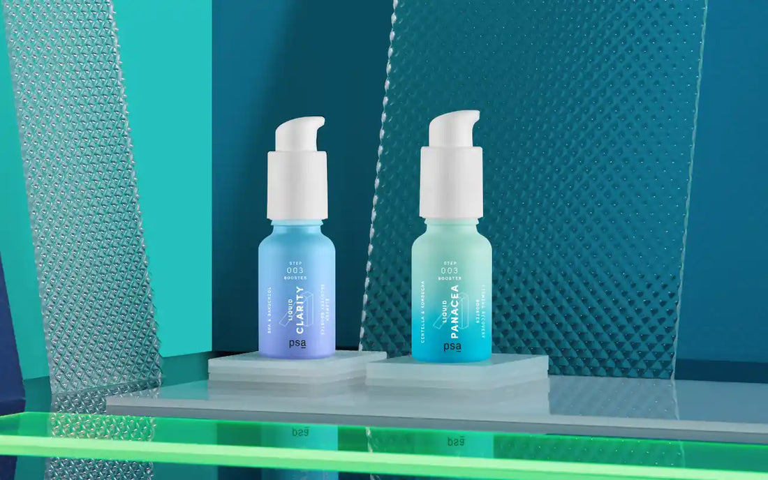 bottles of psa's skincare boosters liquid panacea and liquid clarity on blue and green background