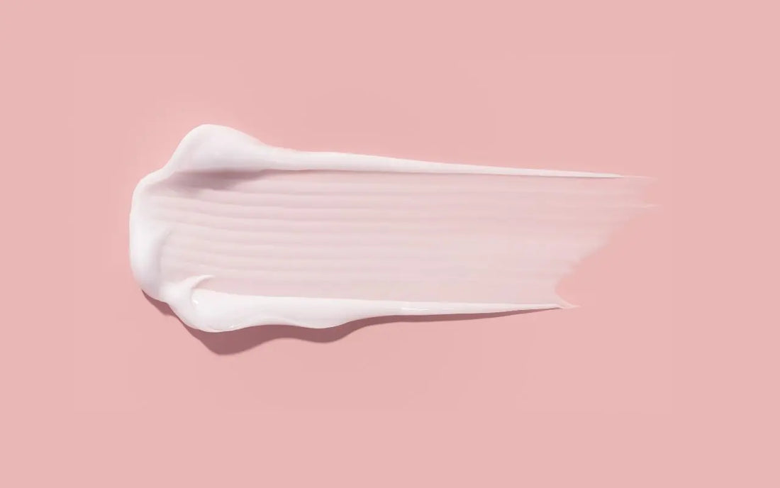 texture spread of a panthenol for skin on a pink background