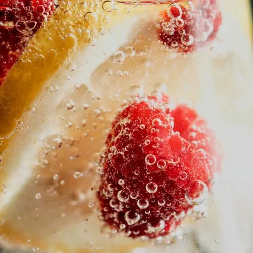 Raspberry, inside the water, surrounded by bubbles, as representative of antioxidants in skincare